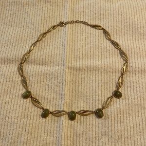 Gold tone metal and green gemstone necklace